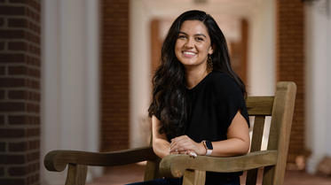 Darden student sitting on bench outside