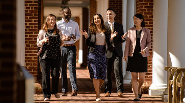 Students and faculty walking down corridor