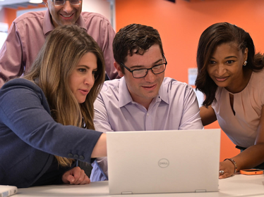 People gathered around computer