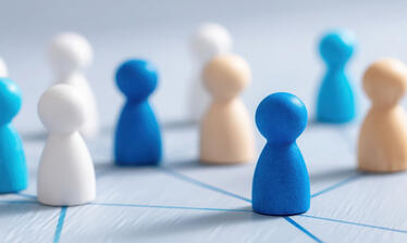 multi color human-shaped game piece figures on a mat